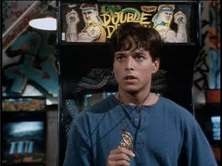 A scene from the Double Dragon movie showing Billy Lee (portrayed by Scott Wolf) standing in front of the arcade game.